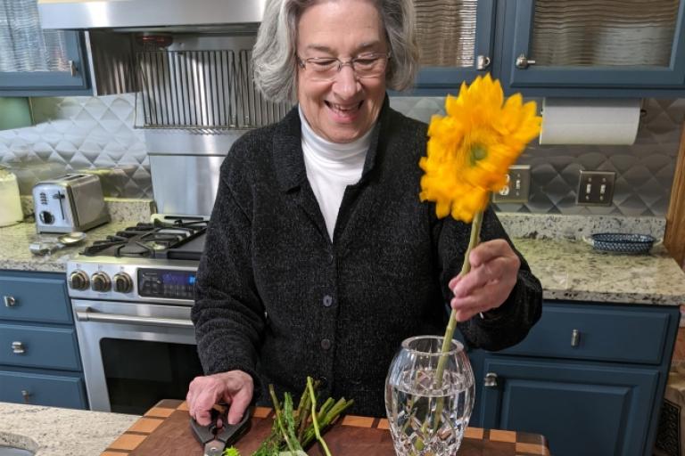 Elder arranging flowers in a care community