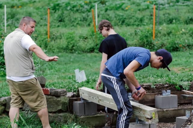 Adolescents and guide working outdoors