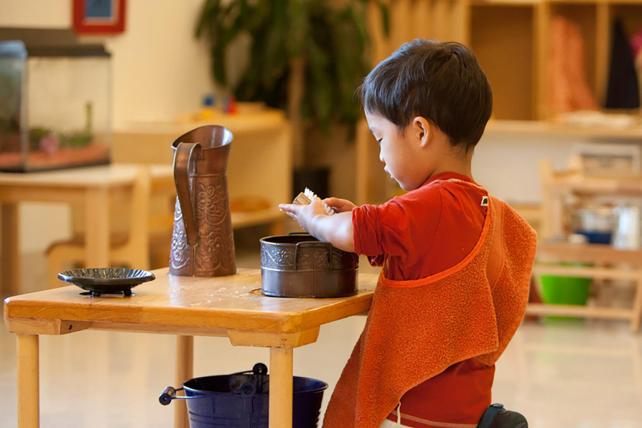 Child hand washing in a Montessori classroom